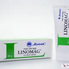 Opakowanie maści Linomag i tubka z zielonymi elementami na białym tle.