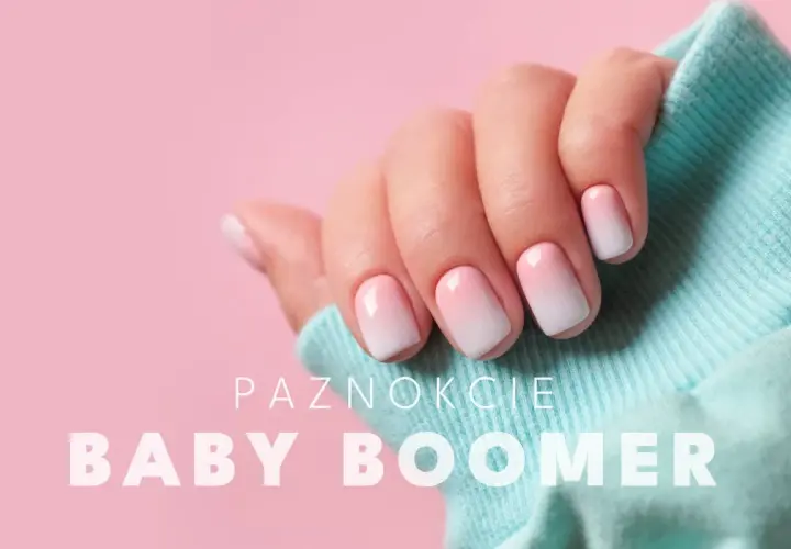 Dłoń z paznokciami w stylu baby boomer, delikatny gradient różu i bieli.
