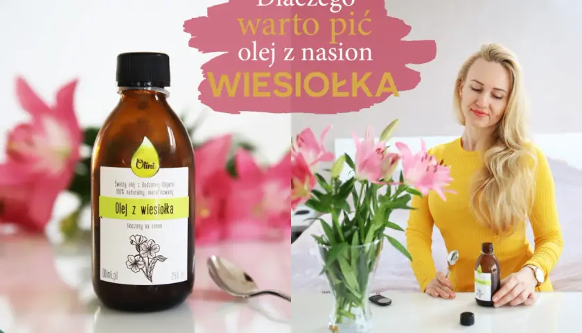 Kobieta z blond włosami trzyma butelkę oleju z wiesiołka. Na stole stoi wazon z kwiatami. Olej z wiesiołka na twarz to naturalne wsparcie dla urody.